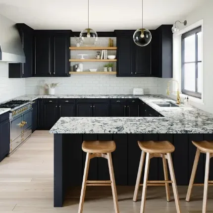 Porous granite countertops in a kitchen with black cabinets against white subway tiles and white walls with light wooden accents.